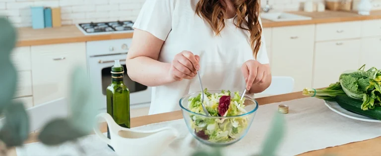Person Preparing a Salad After Finding a Weight Loss Clinic Near Me & Weight Loss Dr Near Me