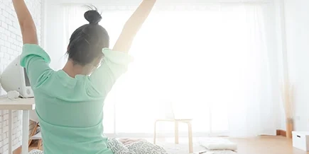 a stretching person out of bed feeling good because of preventative care