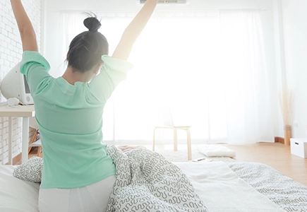 a stretching person out of bed feeling good because of preventative care
