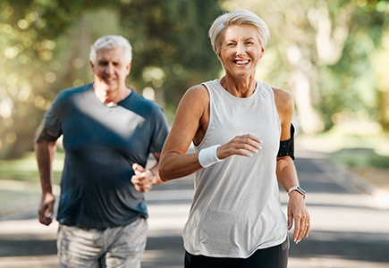 two middle aged people jogging as preventative care