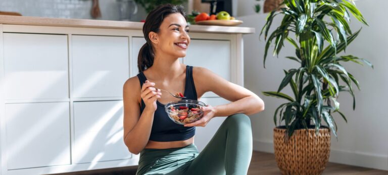 Woman eating a healthy meal after workout, promoting nutrition for managing chronic diseases