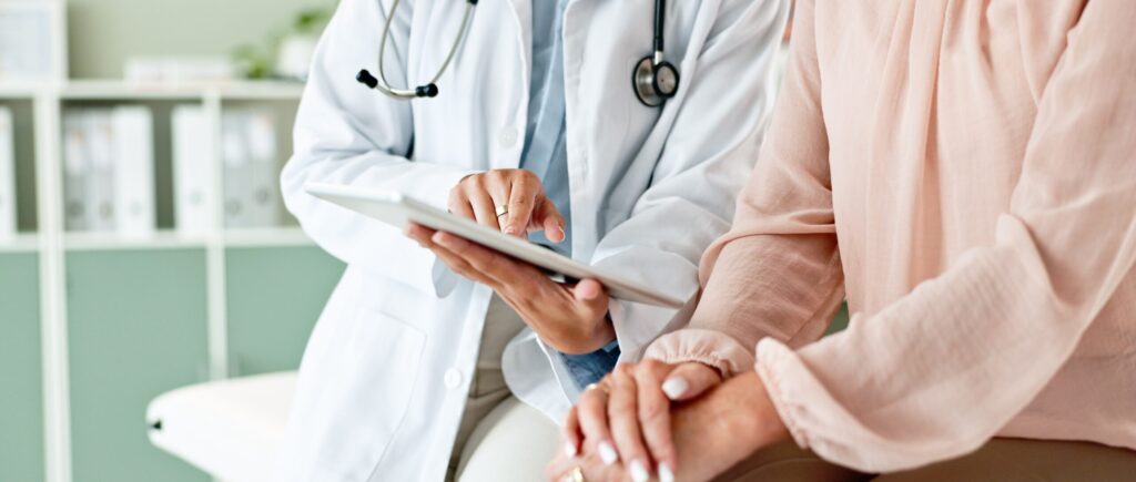 Doctor reviewing medical notes on a tablet with a patient at Two Eleven Health in Avon Lake