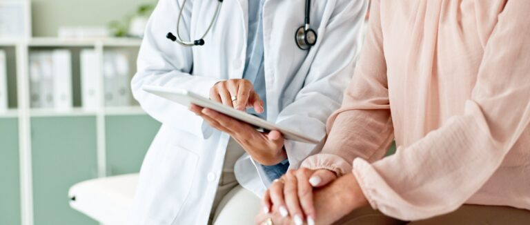 Doctor reviewing medical notes on a tablet with a patient at Two Eleven Health in Avon Lake