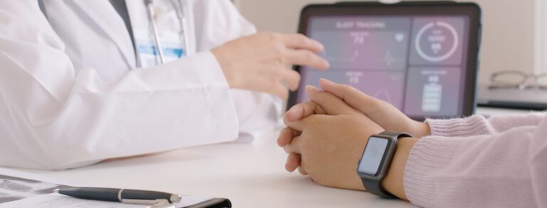 Doctor and patient meeting to discuss preventive healthcare with health data on a tablet.